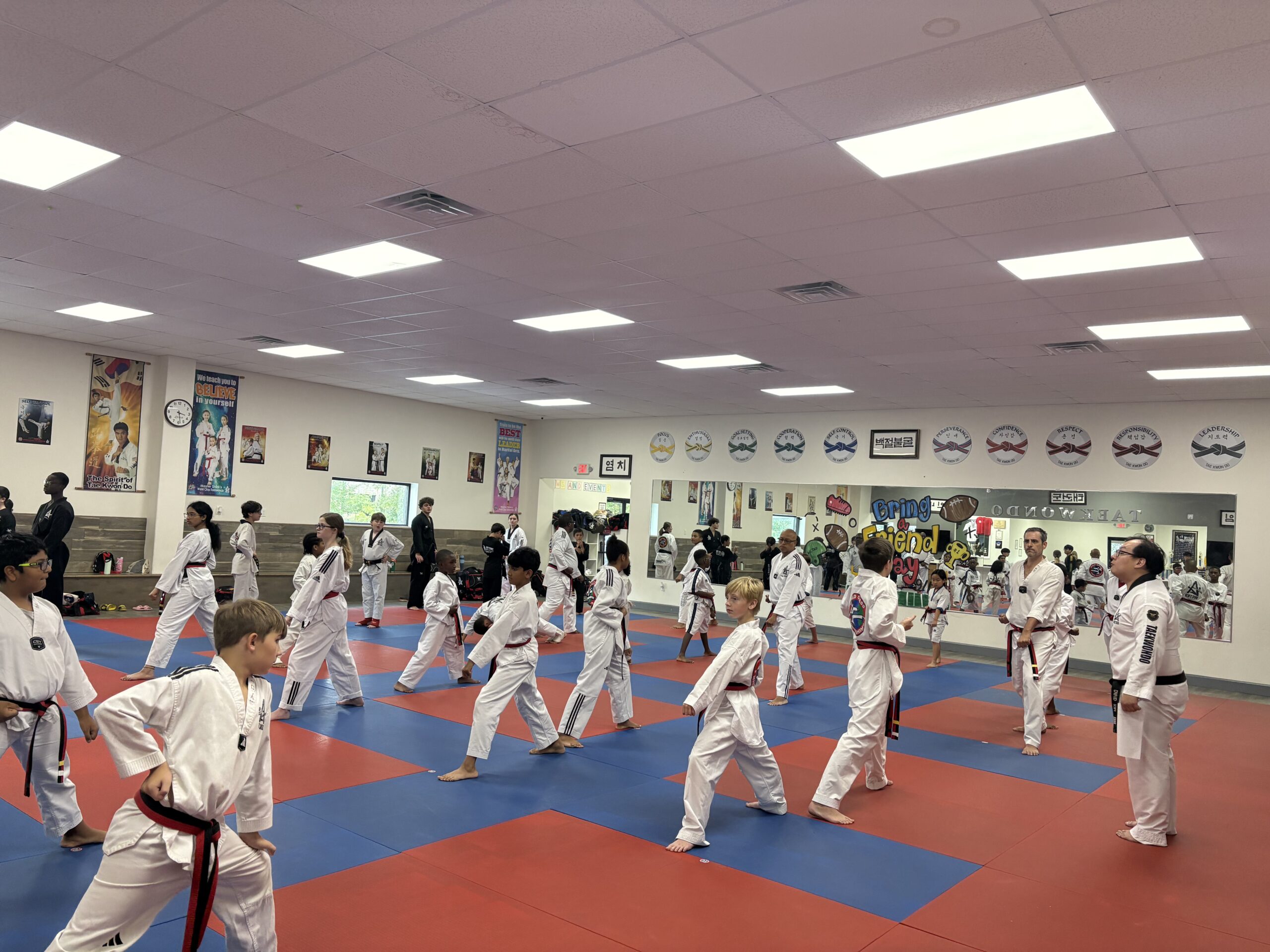 Families participating in Tae Kwon Do training at Master Shim's